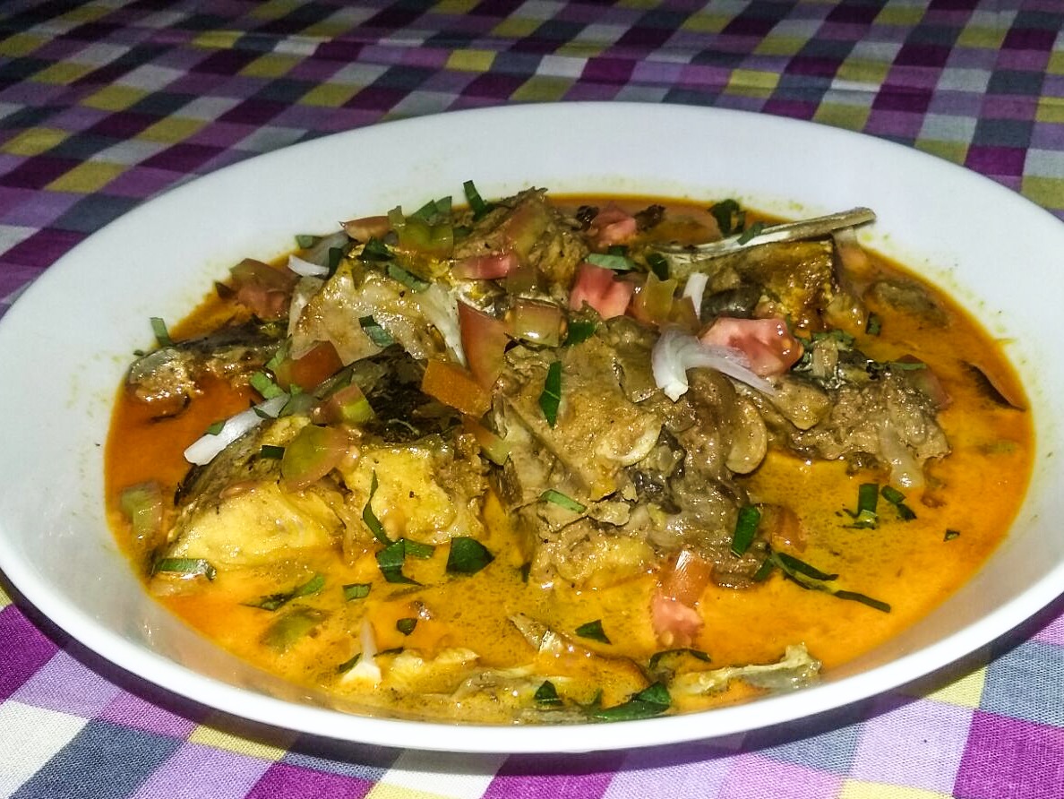 A Sri Lankan fish curry with rice and side dishes
